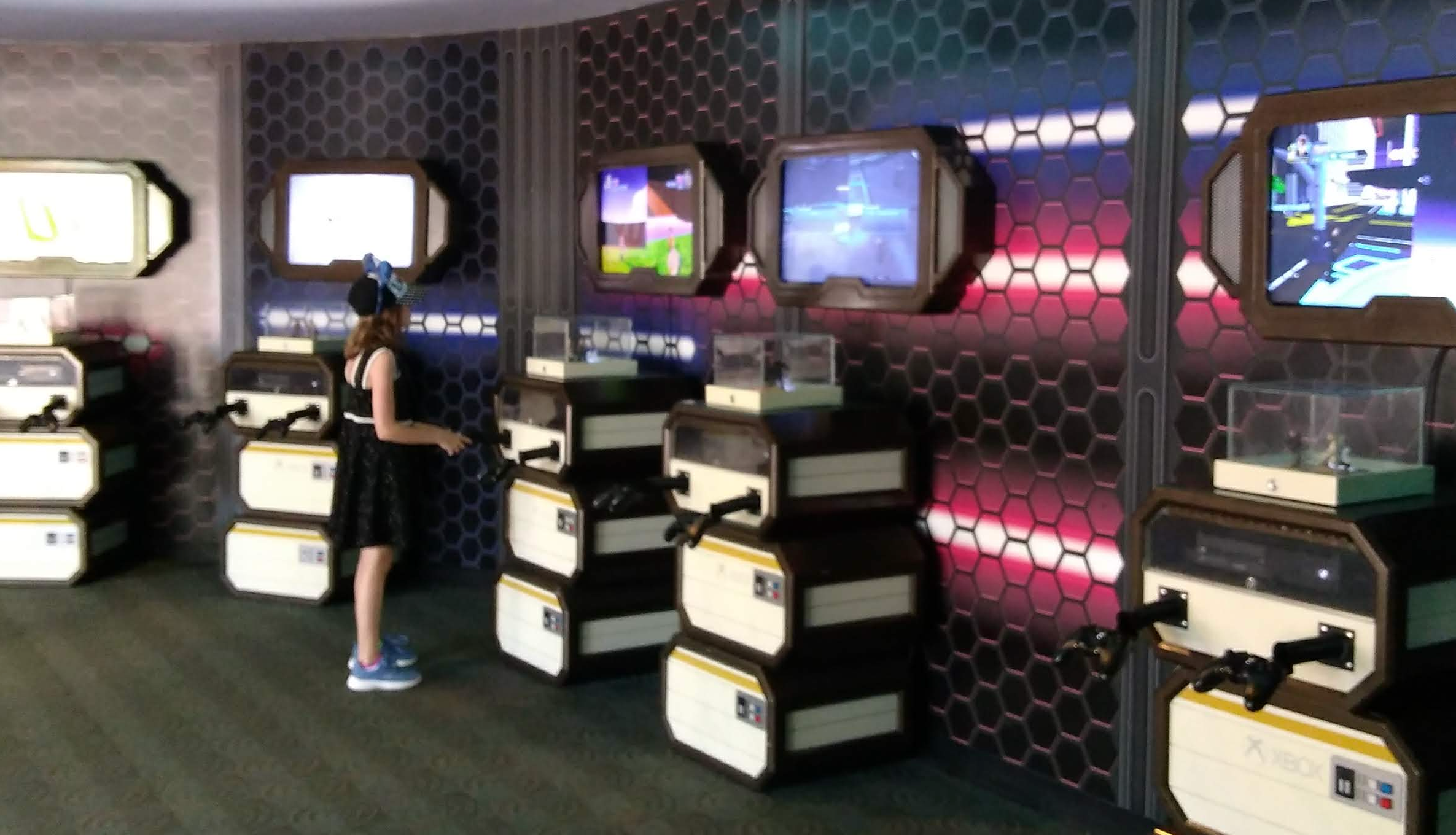 A child plays at one of many video game kiosks. All of the kiosks are empty besides hers